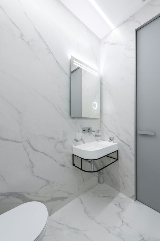 Simple modern marble tiled white UK bathroom