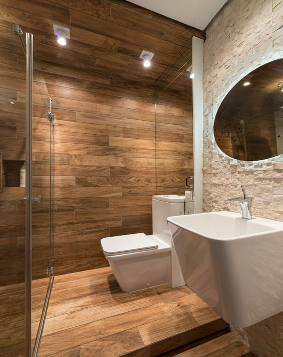 Wood-themed tiling in a modern Scandinavian baththroom with decorative wall tiling behind the sink mirror