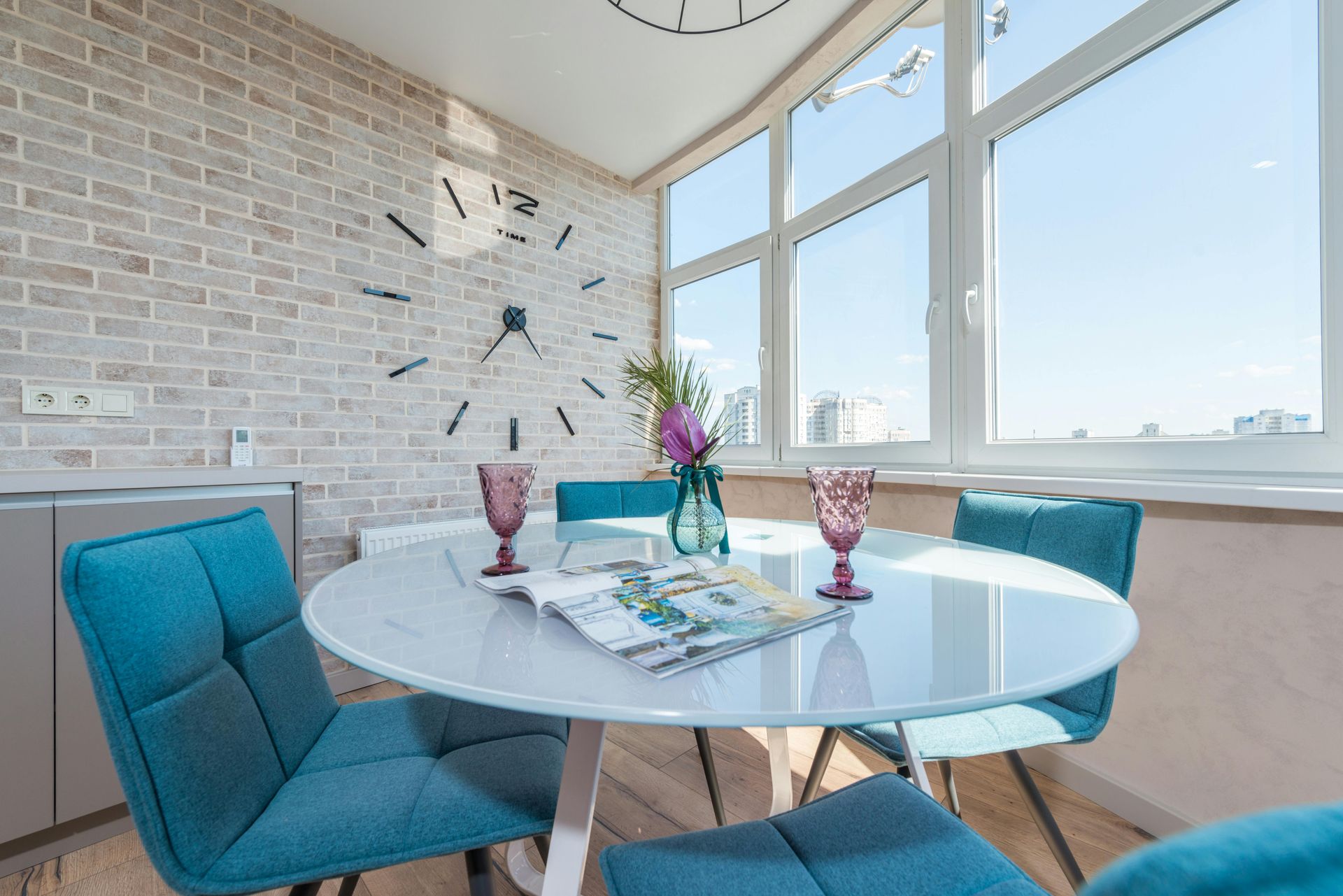 A kitchen wall expertly tiled by Orchid Tiling with light brown subway tiles. Outside the window is a view of Newport, Wales.