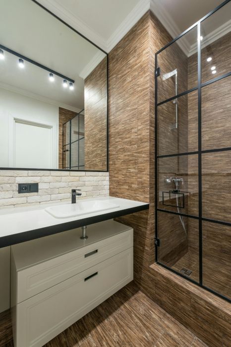 A bathroom with a sink , mirror and shower stall in Newport, Wales