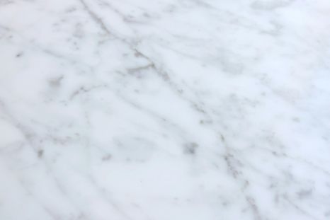 A close up of a white marble counter top.