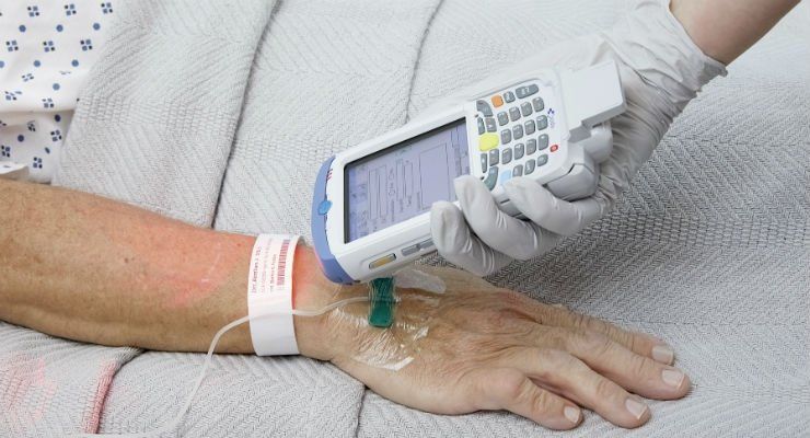 a nurse is using a device on a patient 's arm