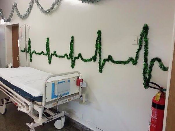 a hospital bed with a heartbeat made out of tinsel on the wall .
