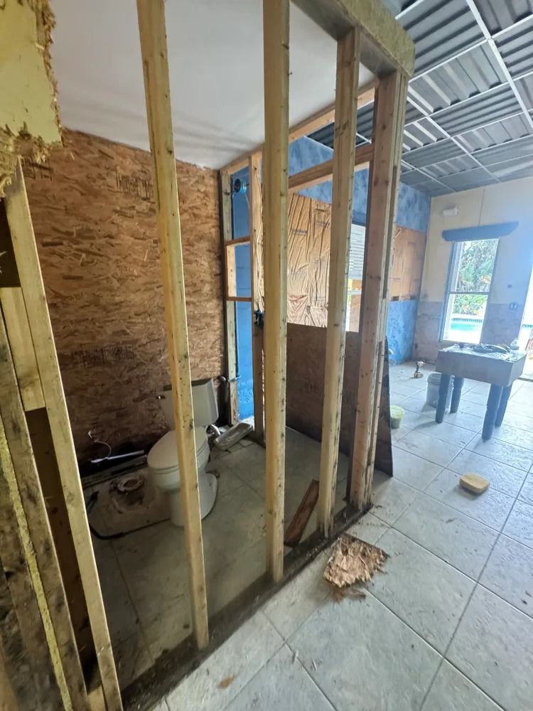 A room with a toilet and a table in it is being remodeled.
