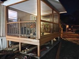 A house with a screened in porch at night