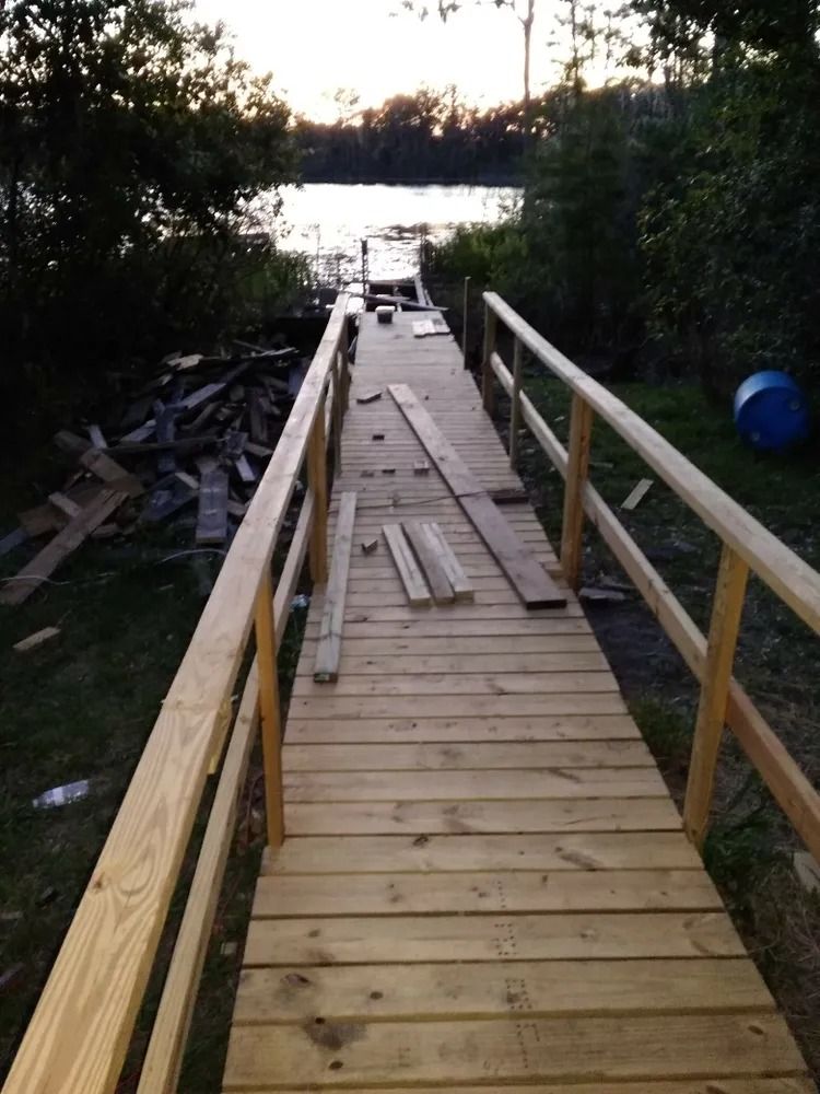 A wooden walkway leading to a body of water
