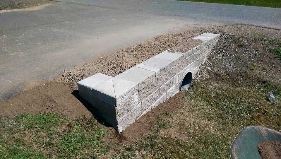 A concrete wall is being built next to a road.