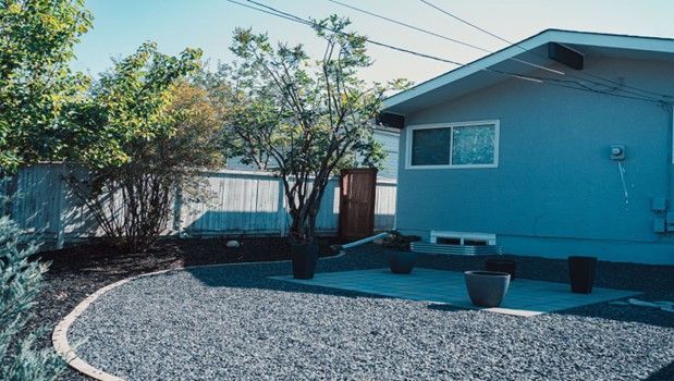 Blue House with a Gravel Yard – Calgary, AB – As The Sod Turns Landscape & Design Inc.