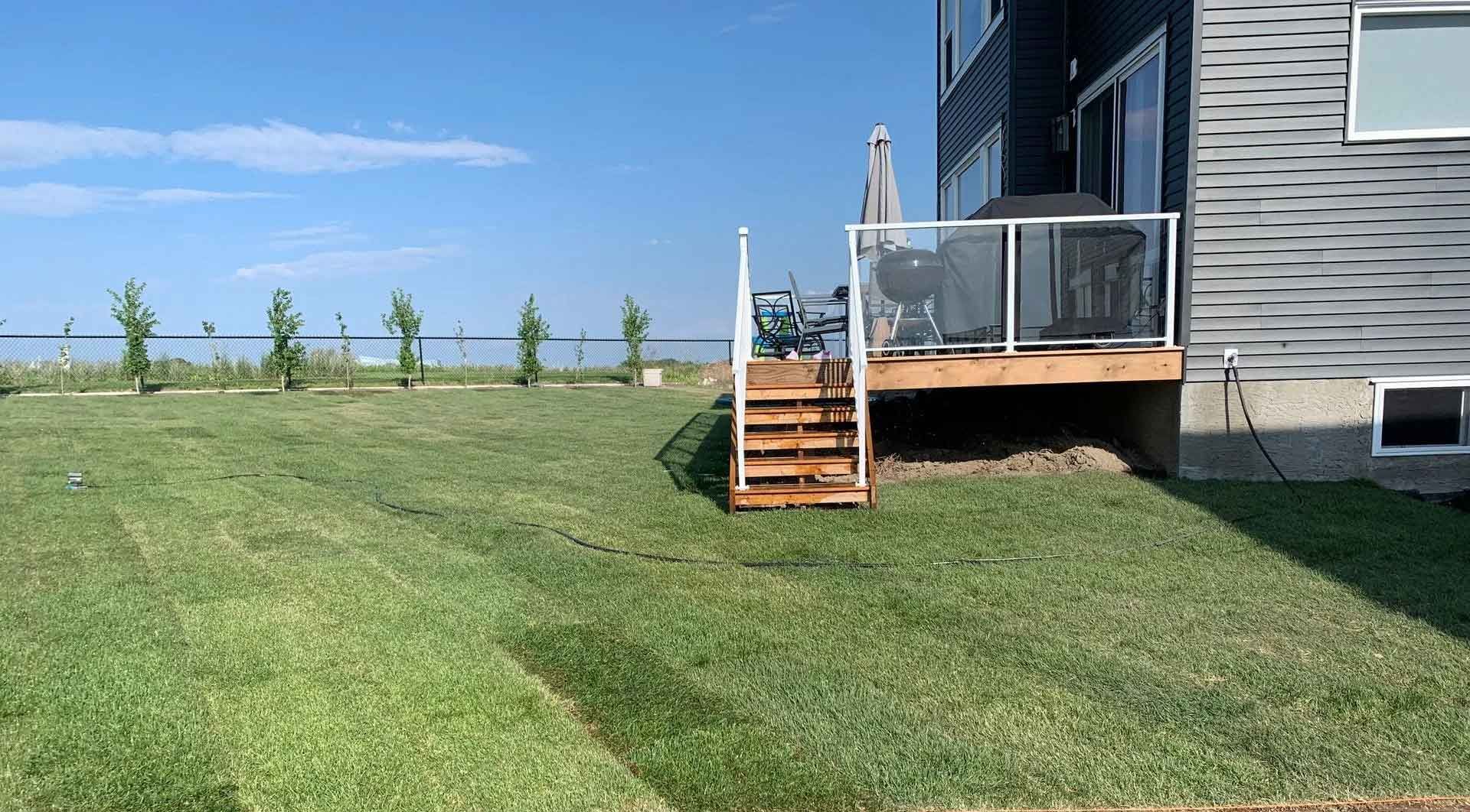 A house with a deck and stairs in the backyard.