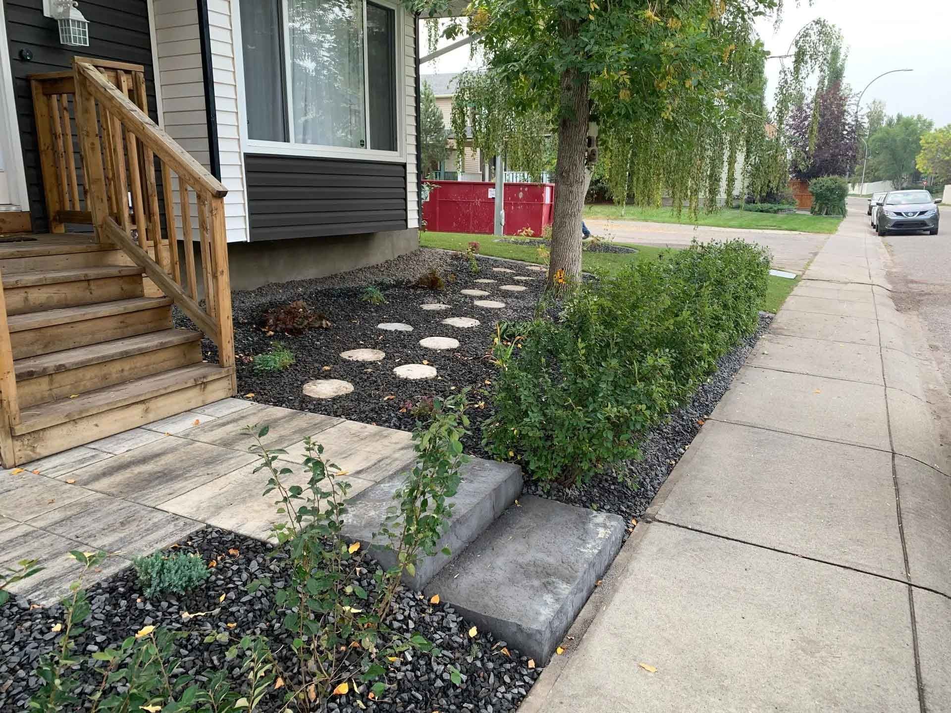 A house with a walkway leading to the front door.