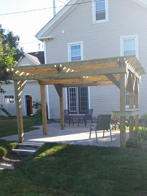 A house with a pergola in front of it