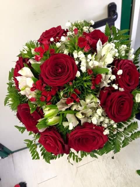 composizione di fiori con rose rosse e fiorellini bianchi