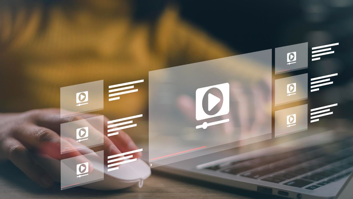 Person using a laptop, interacting with a digital interface showing video thumbnails, a play button, and editing controls.