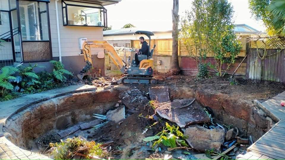 A bobcat s330 is parked in front of a house.