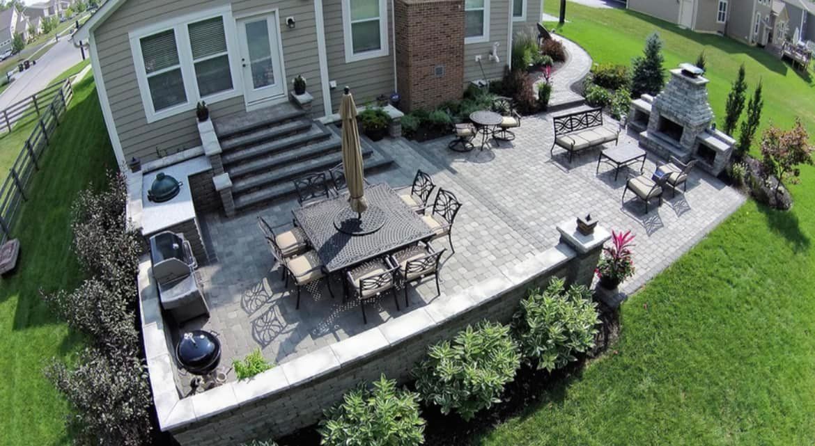 An aerial view of a house with a patio and a fireplace.