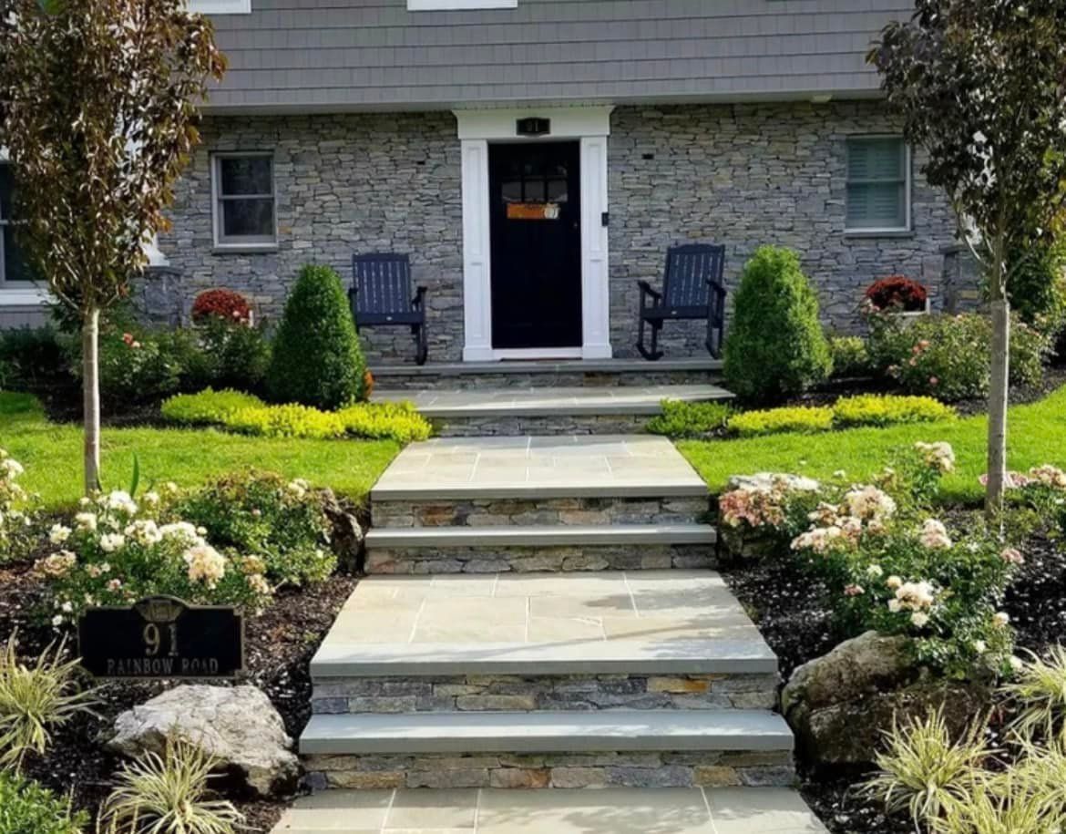 A stone walkway leading to the front door of a house.