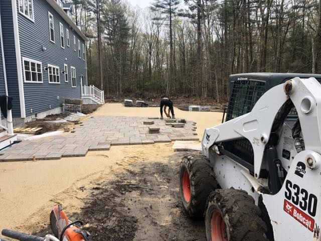 A bobcat s330 is parked in front of a house.
