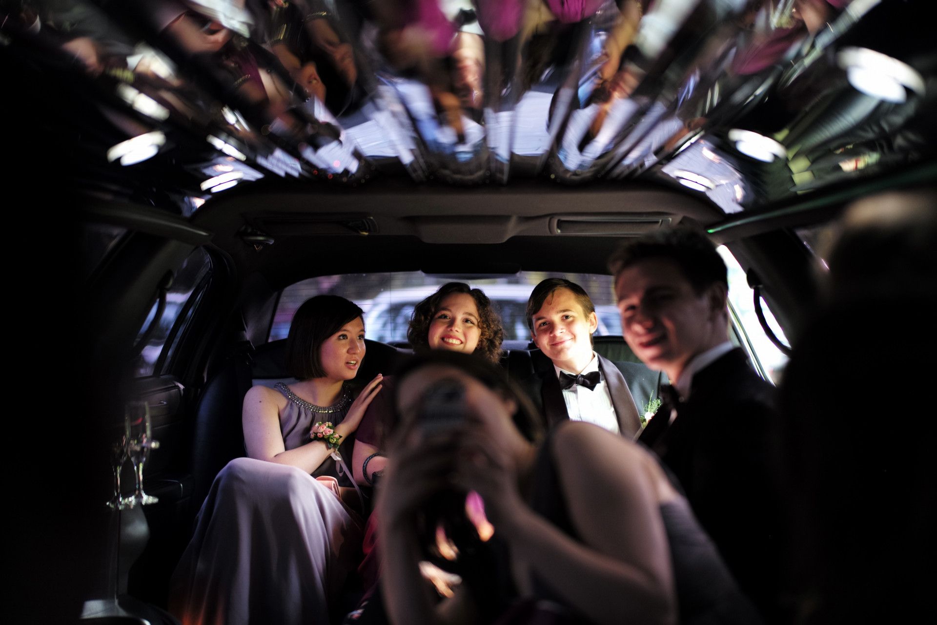 A group of people are sitting in a limousine.