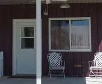 Three Chairs On The Porch Of House - Clifton, TX - Bosque Supply Company