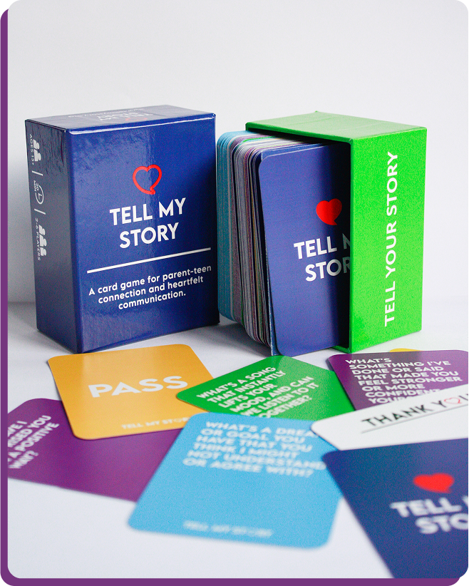 A box of tell my story cards sits next to a box of tell your story cards