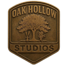 Oak Hollow Studios bronze shield logo with oak tree and children silhouette