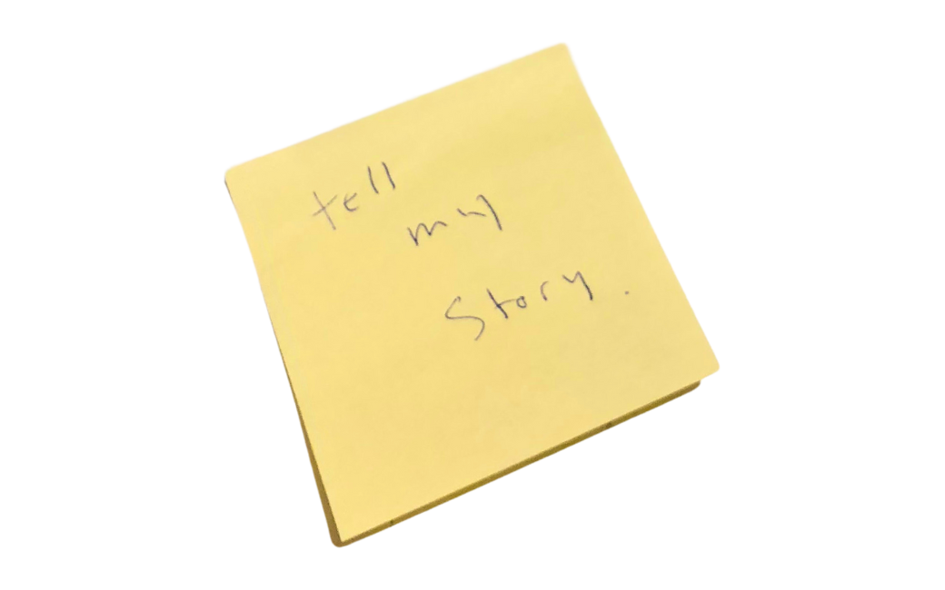 A yellow sticky note that says tell my story