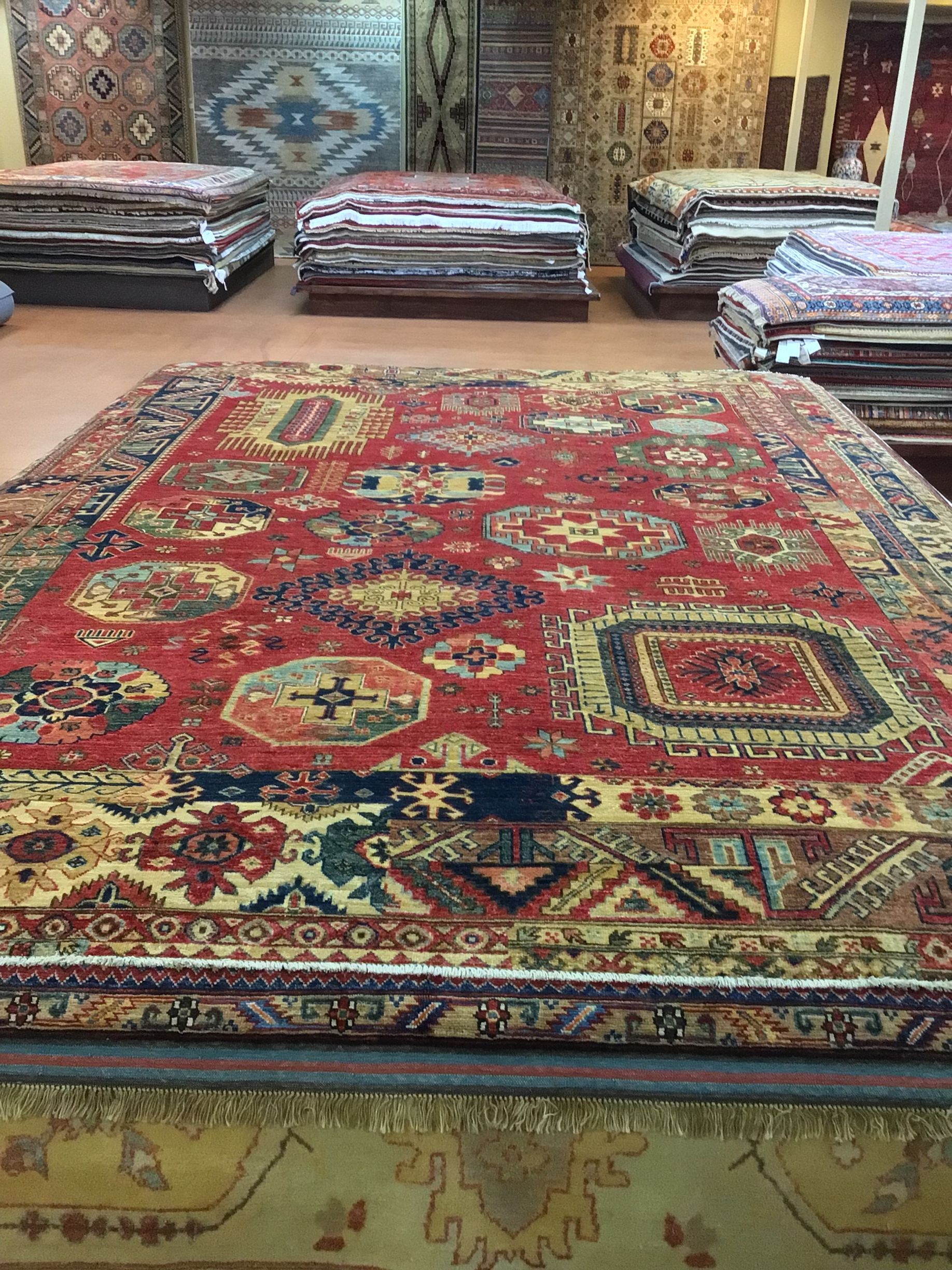A large rug is sitting on top of a table in a store.