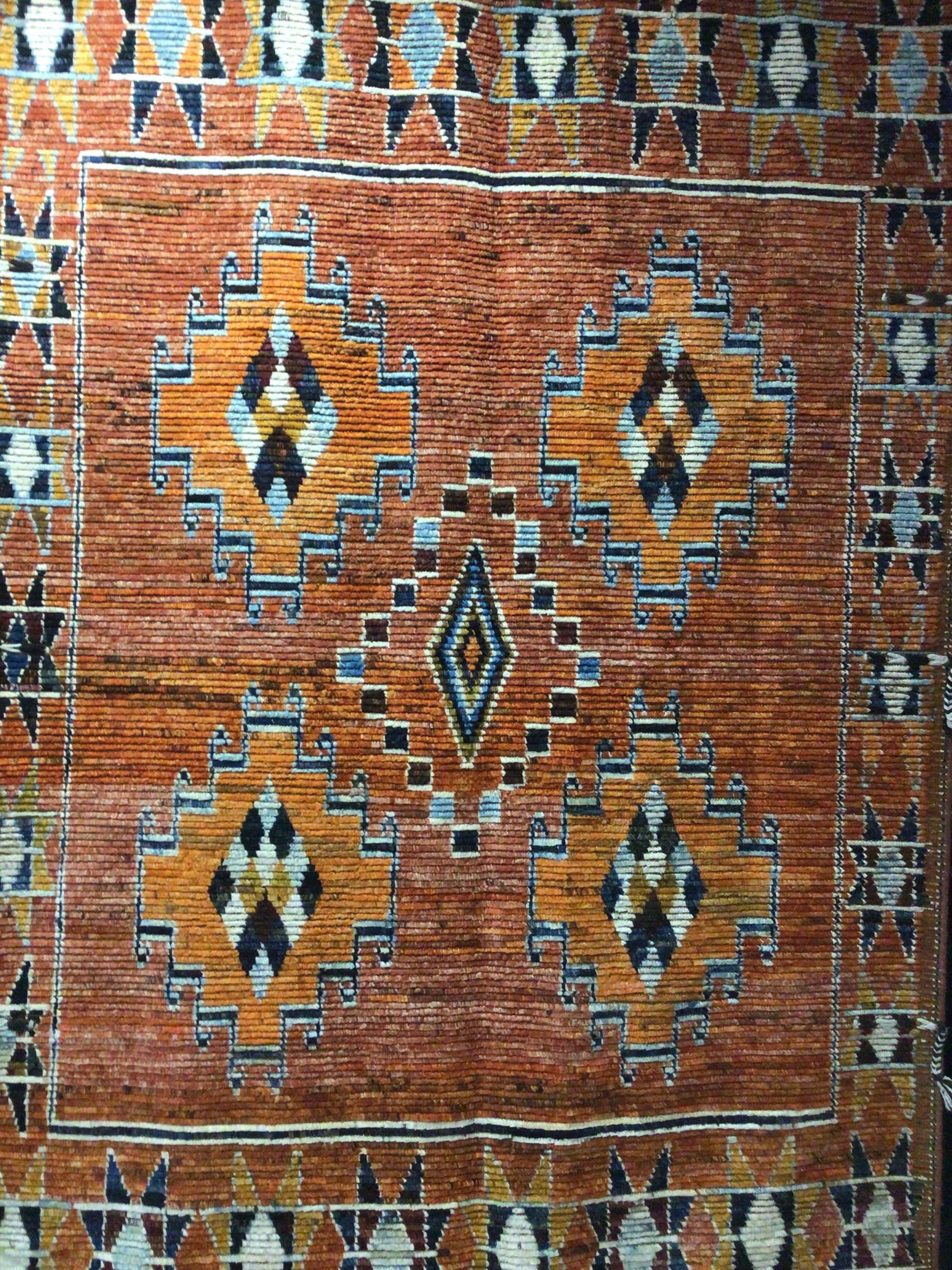 A close up of a rug with a geometric pattern on it.