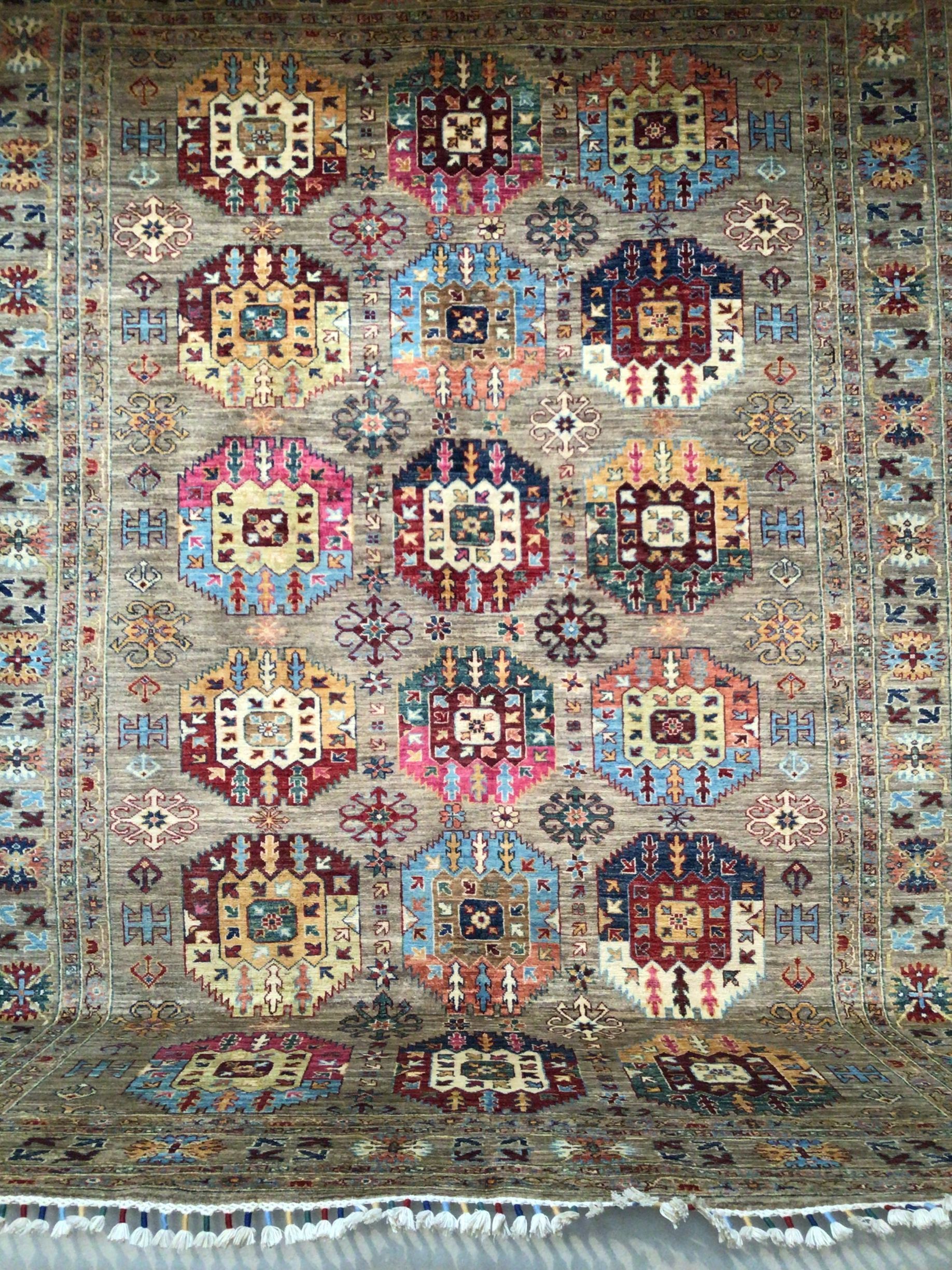 A colorful rug with a pattern on it is sitting on a table.