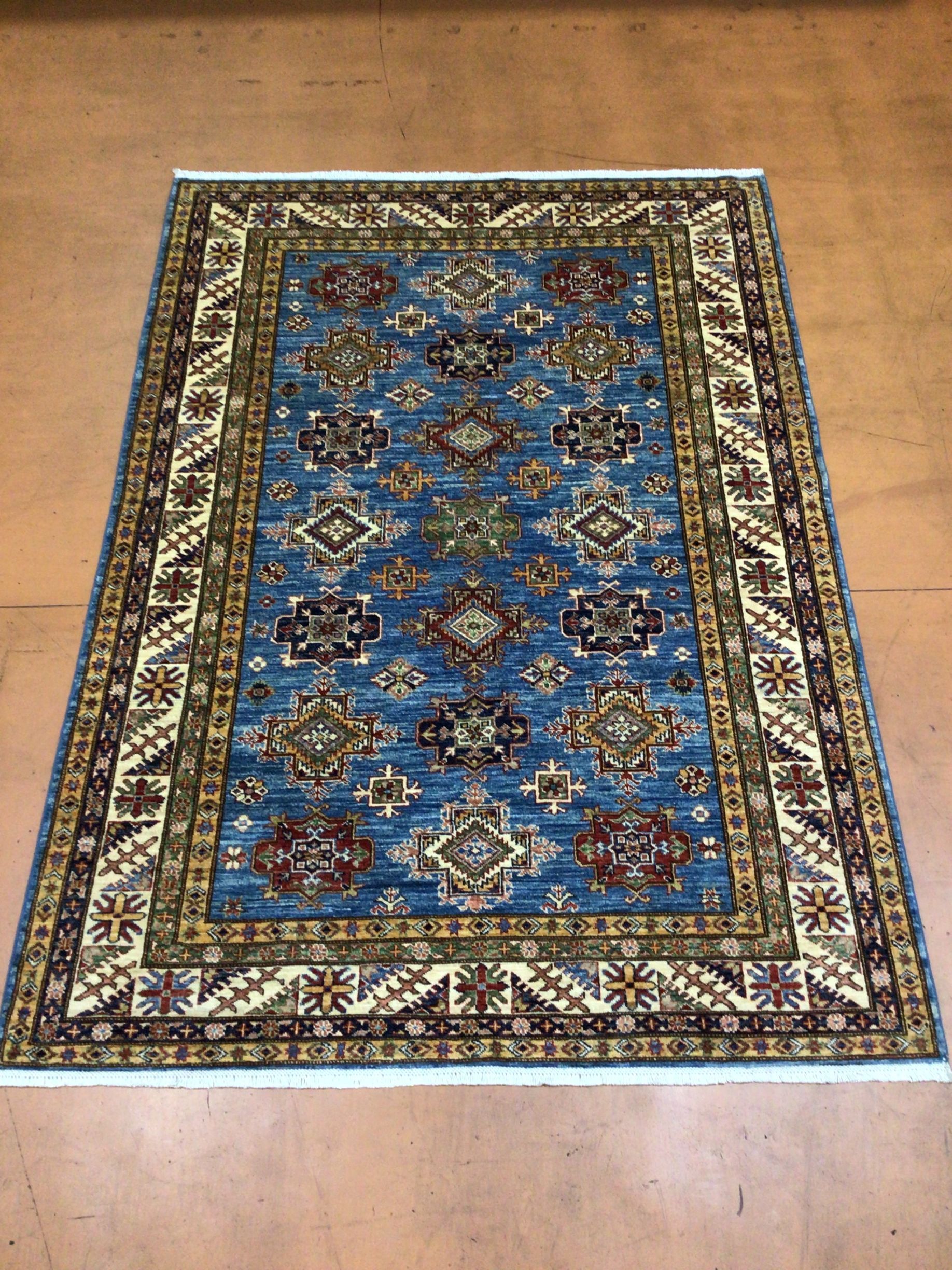 A blue rug is sitting on a wooden floor.