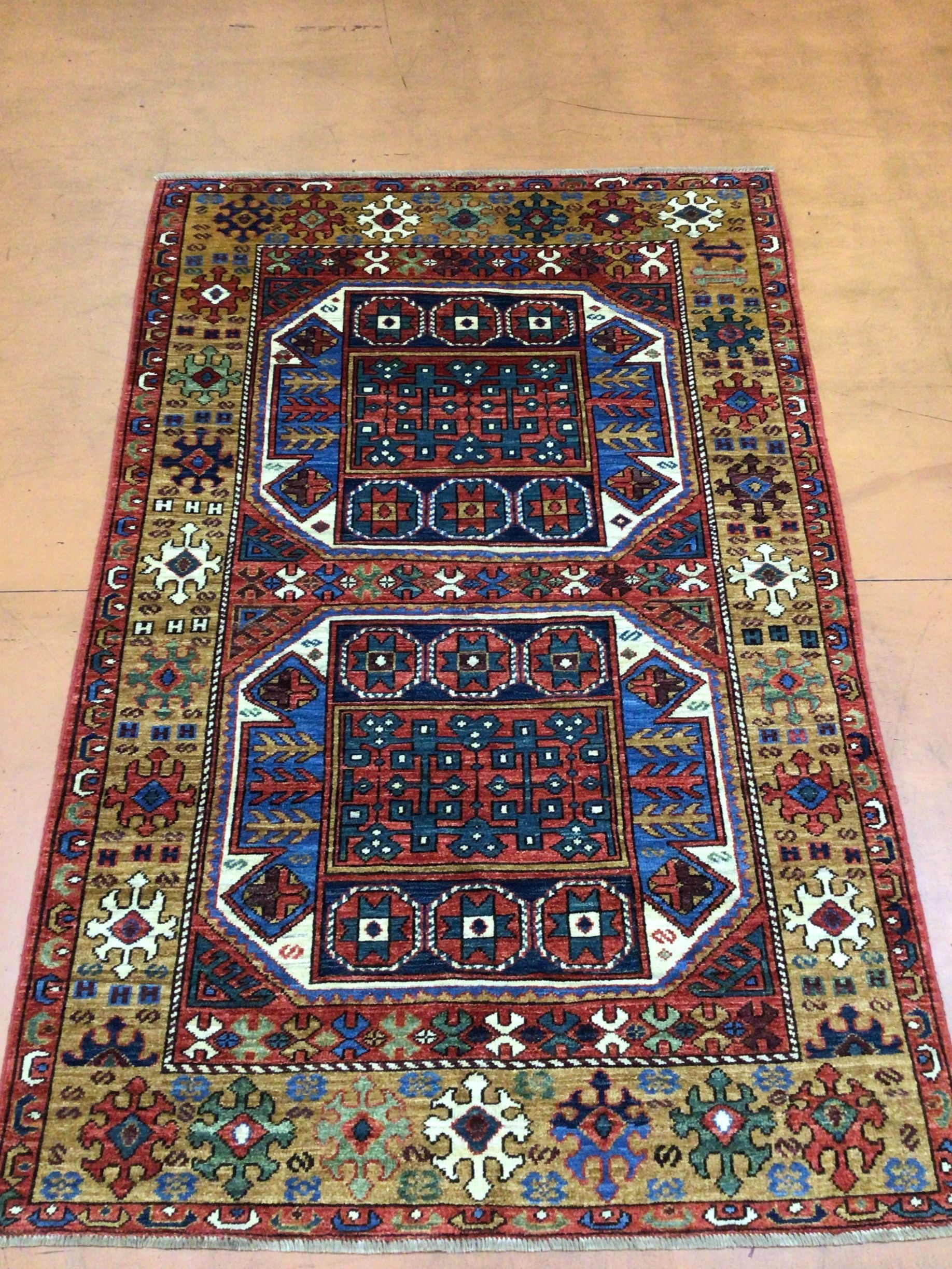 A colorful rug is sitting on a wooden floor.