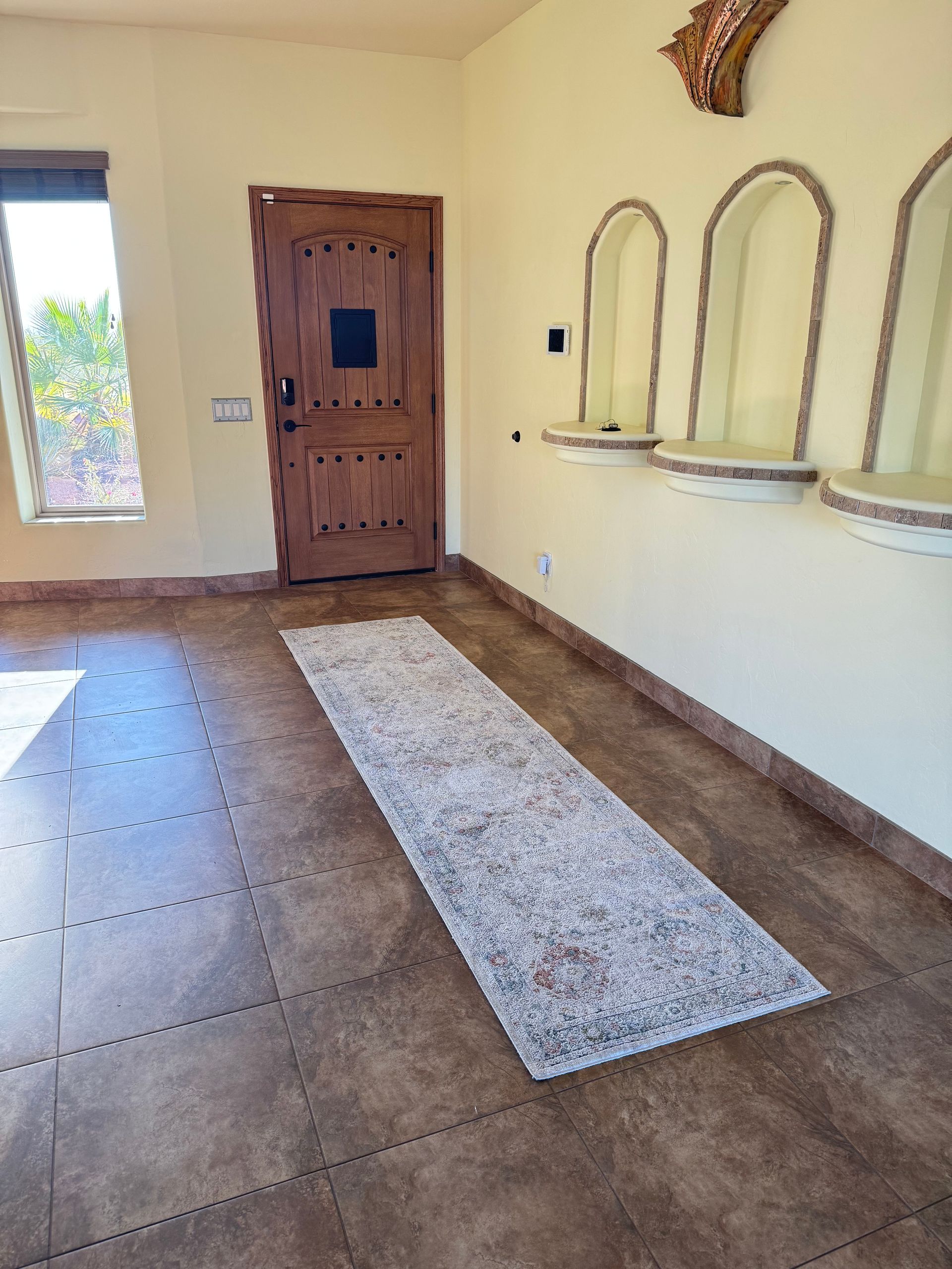 There is a rug on the floor in the middle of the room.