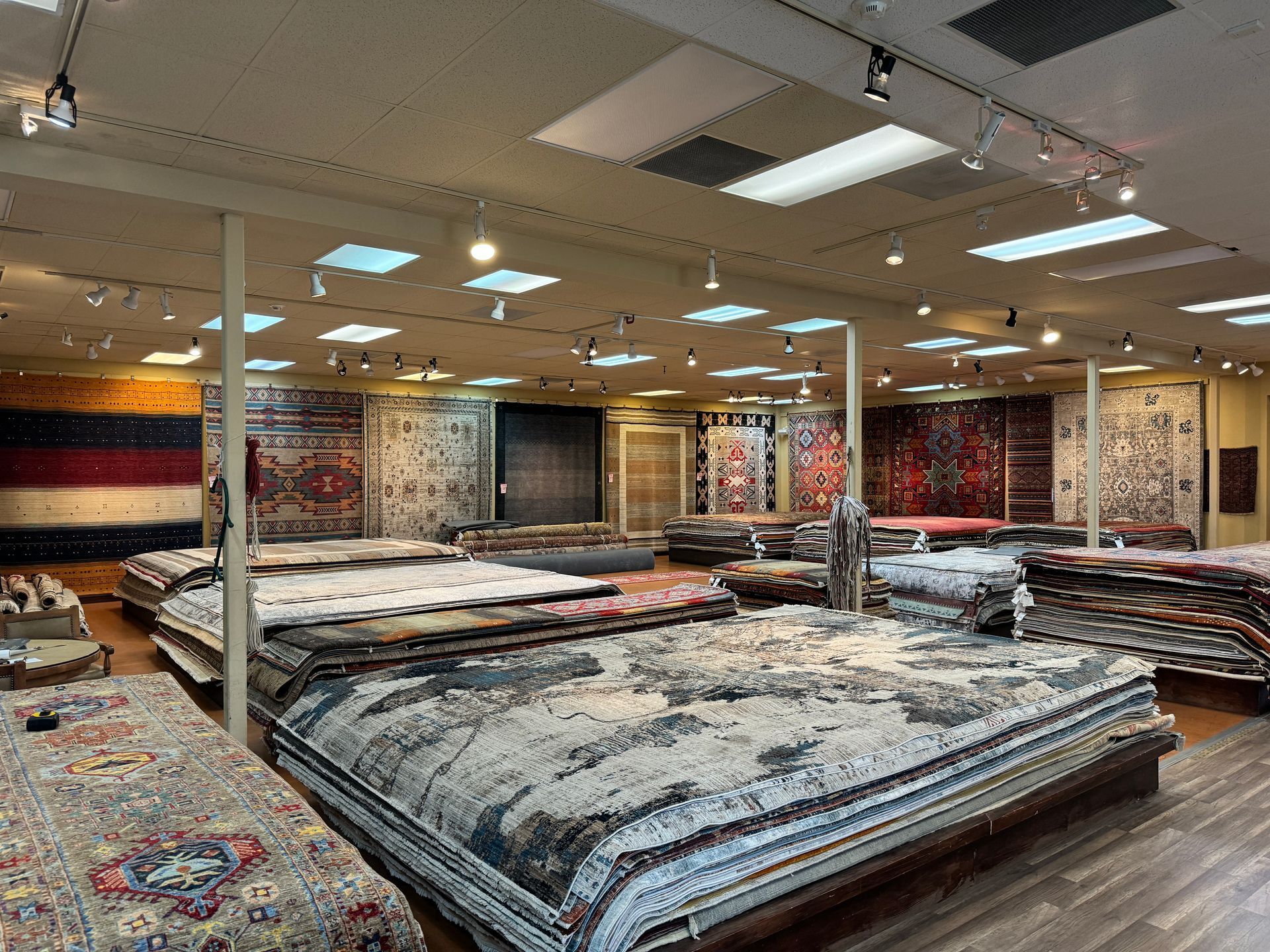 A large room filled with lots of rugs.