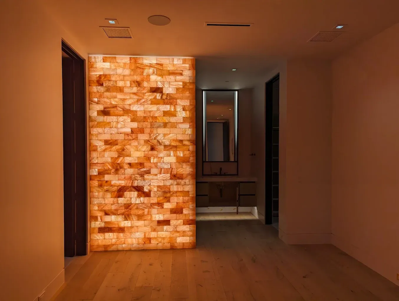A hallway with a brick wall in the middle of it