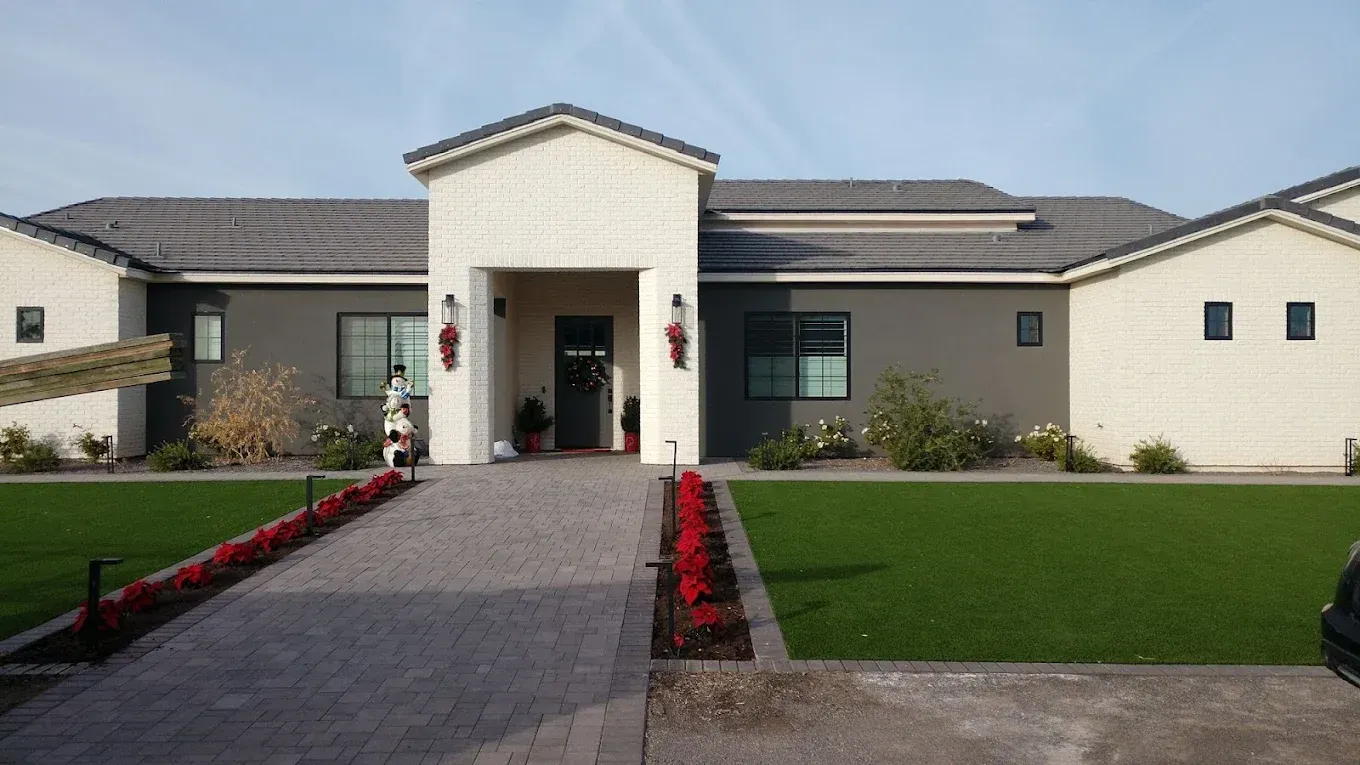 A large house with a lush green lawn in front of it