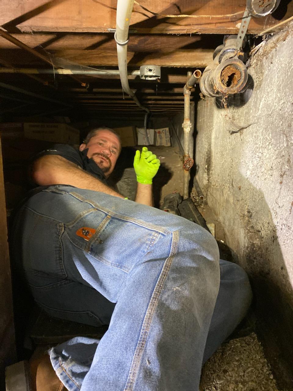 Plumber working in small space