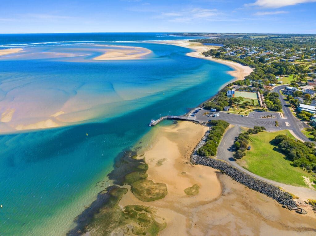 An Aerial View of a River Flowing Into the Ocean Next to a Beach — Port Stephens Removals & Storage In Soldiers Point, NSW