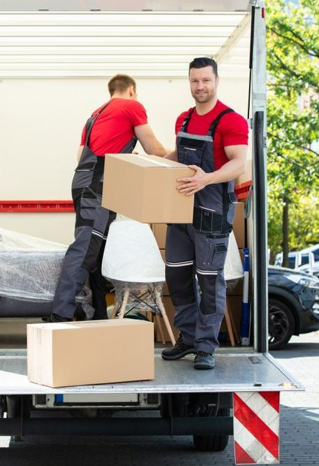 Two Men Are Loading Boxes Into A Moving Truck — Port Stephens Removals & Storage In Dungog, NSW