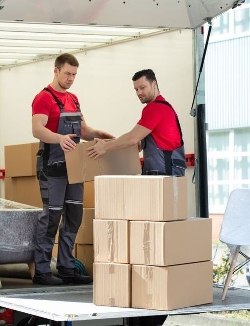 Two Men Are Loading Boxes Into A Truck — Port Stephens Removals & Storage In Dungog, NSW