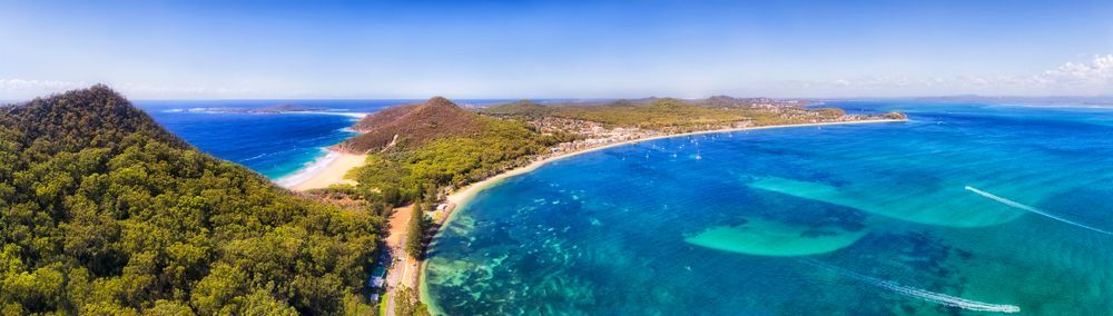 An Aerial View Of A Tropical Island In The Middle Of The Ocean — Port Stephens Removals & Storage In Nelson Bay, NSW
