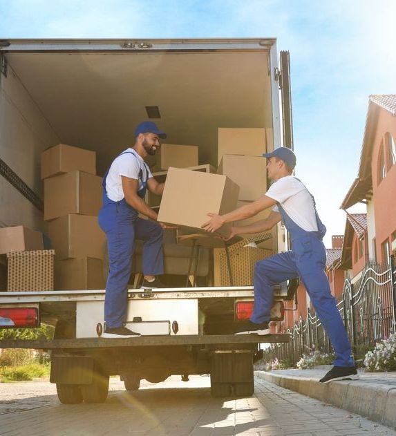 Two Men Are Loading Boxes Into A Truck — Port Stephens Removals & Storage In Nelson Bay, NSW