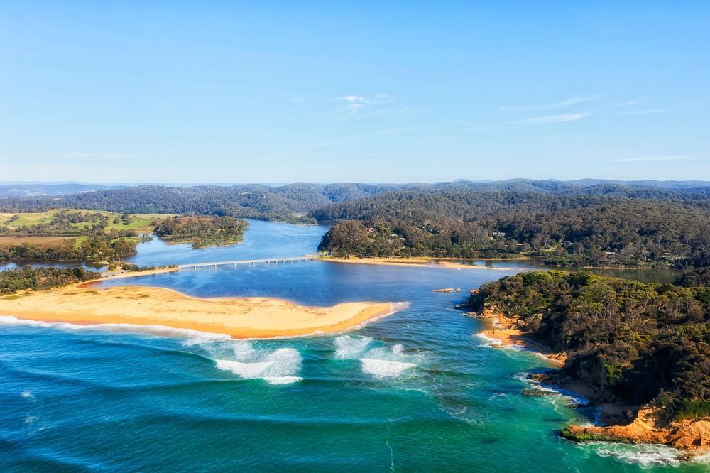 An Aerial View Of A Body Of Water Surrounded By Trees And A Beach — Port Stephens Removals & Storage In Nelson Bay, NSW