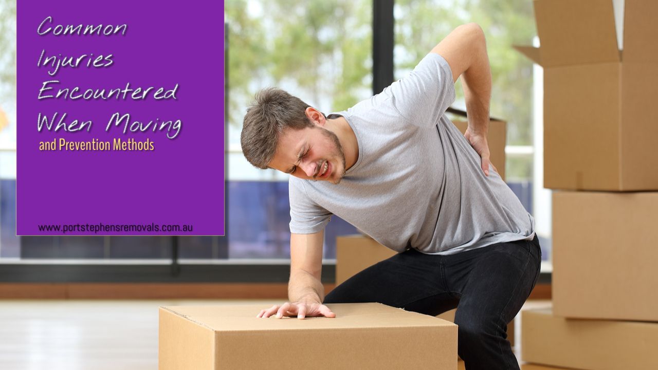 A Man Is Sitting On A Cardboard Box With His Back In Pain — Port Stephens Removals & Storage In Salt Ash, NSW