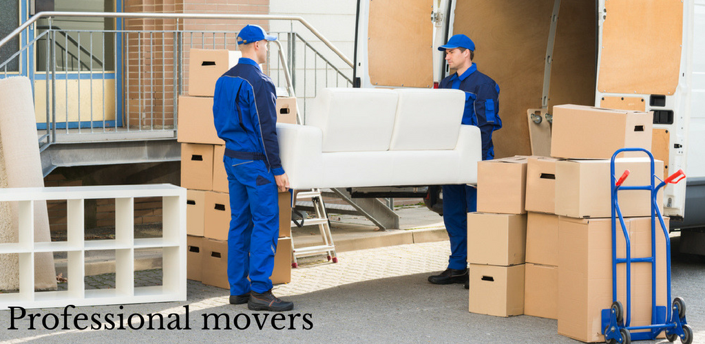Two Professional Movers Are Loading A Couch Into A Truck — Port Stephens Removals & Storage In Salt Ash, NSW