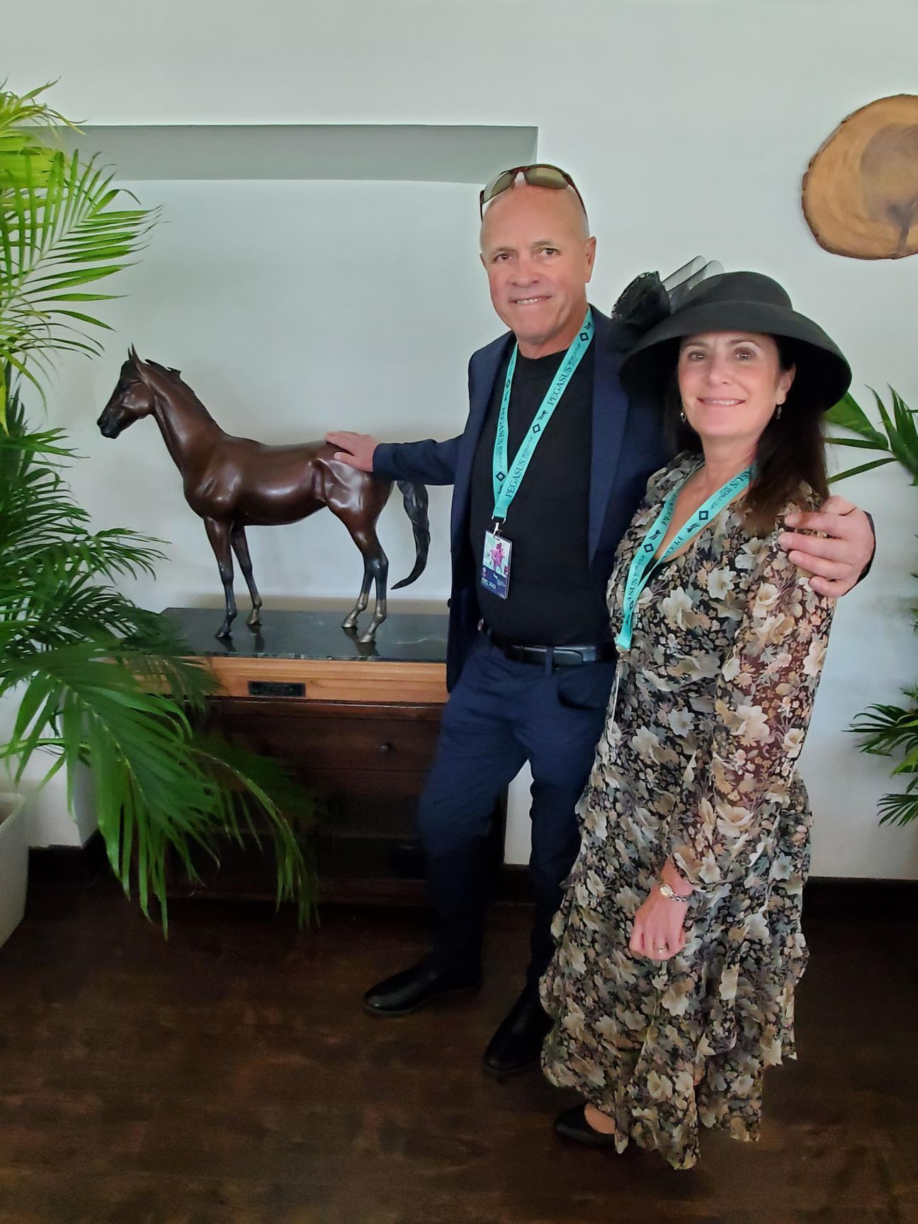 A man and a woman are standing next to a statue of a horse.