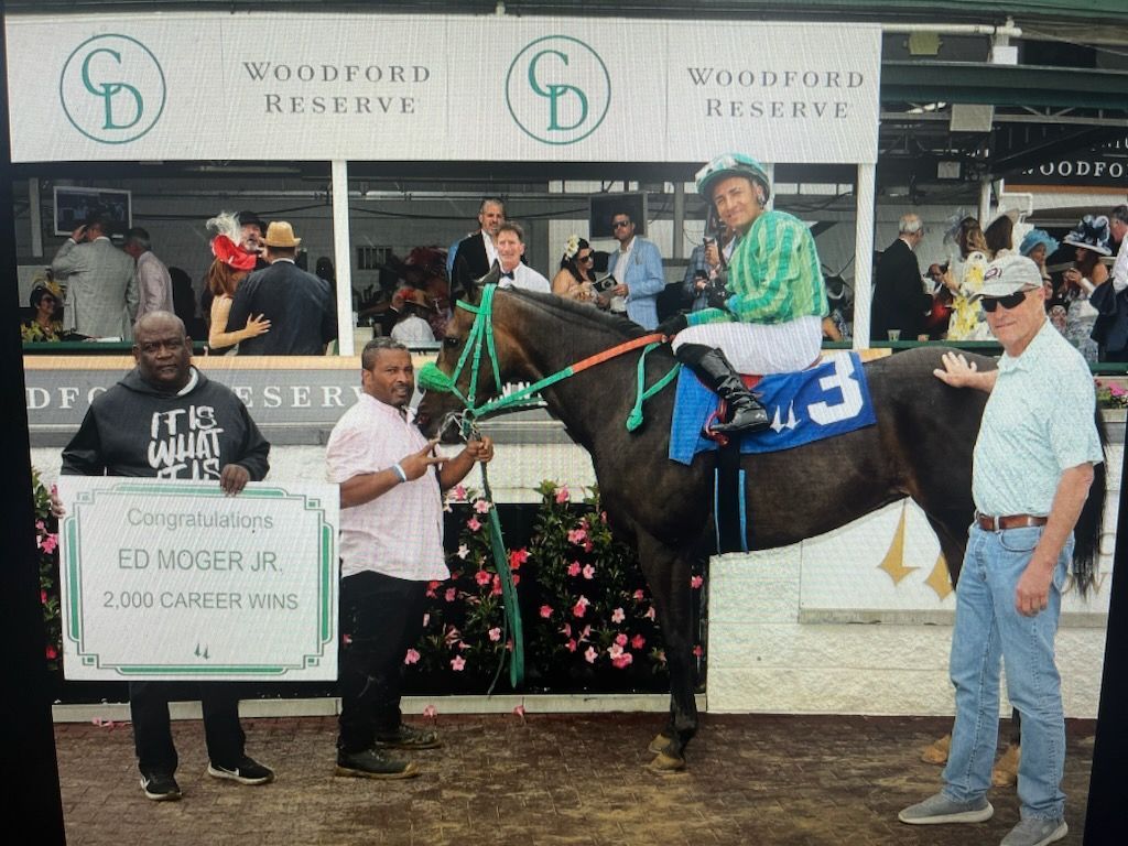 A jockey on a horse with the number 3 on the back