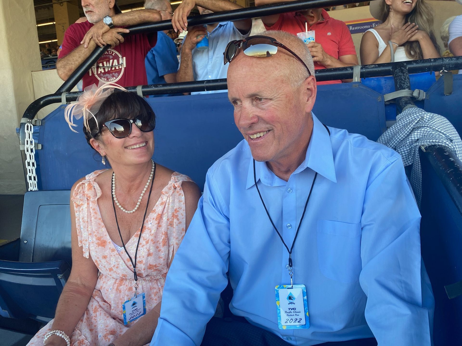 A man and a woman are sitting next to each other in a stadium.