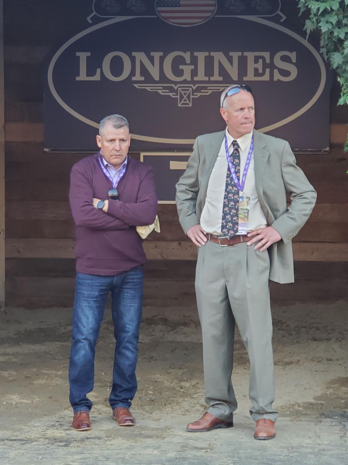 Two men standing in front of a longines sign