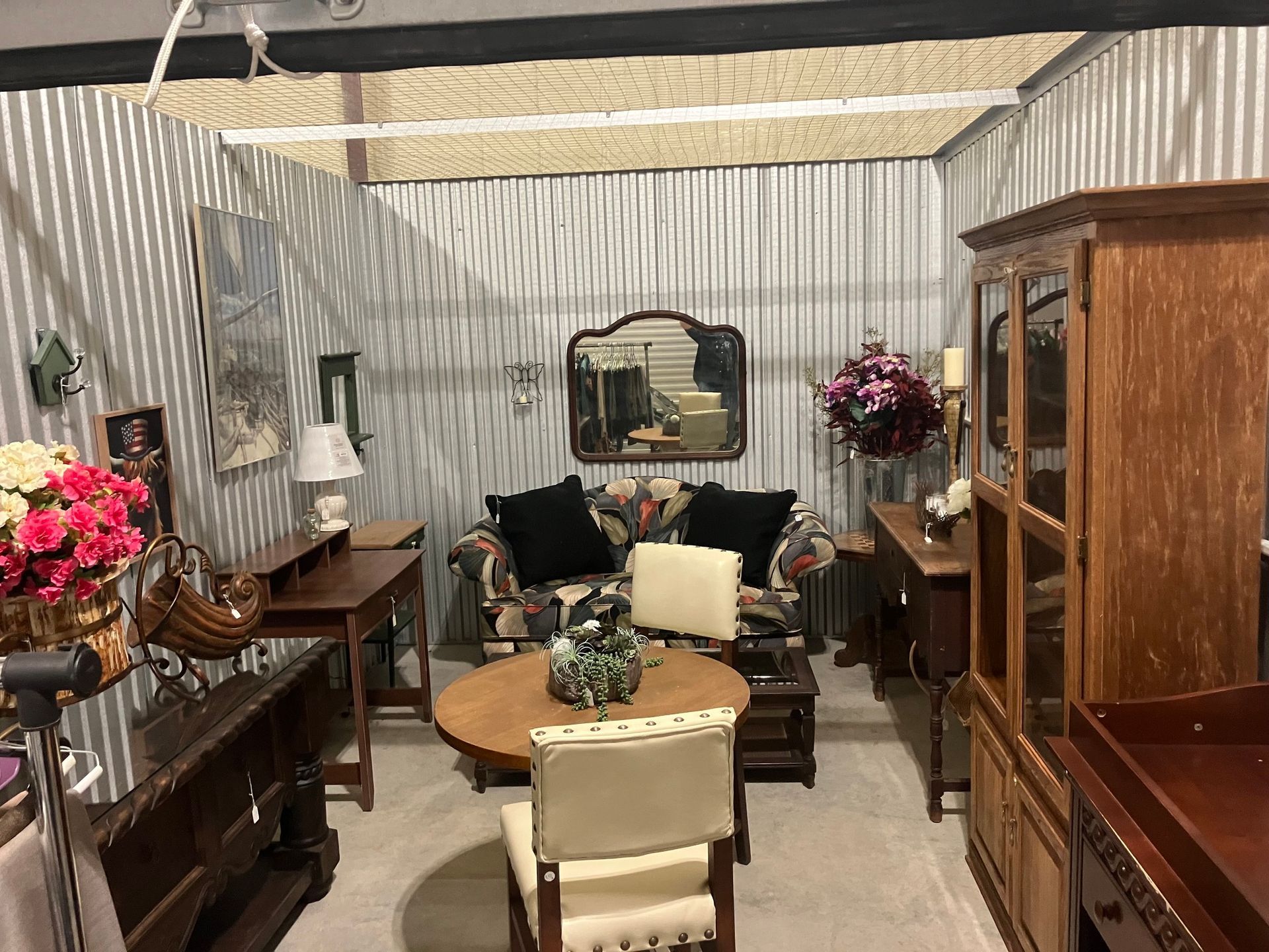 Storage unit with assorted used furniture and decor.
