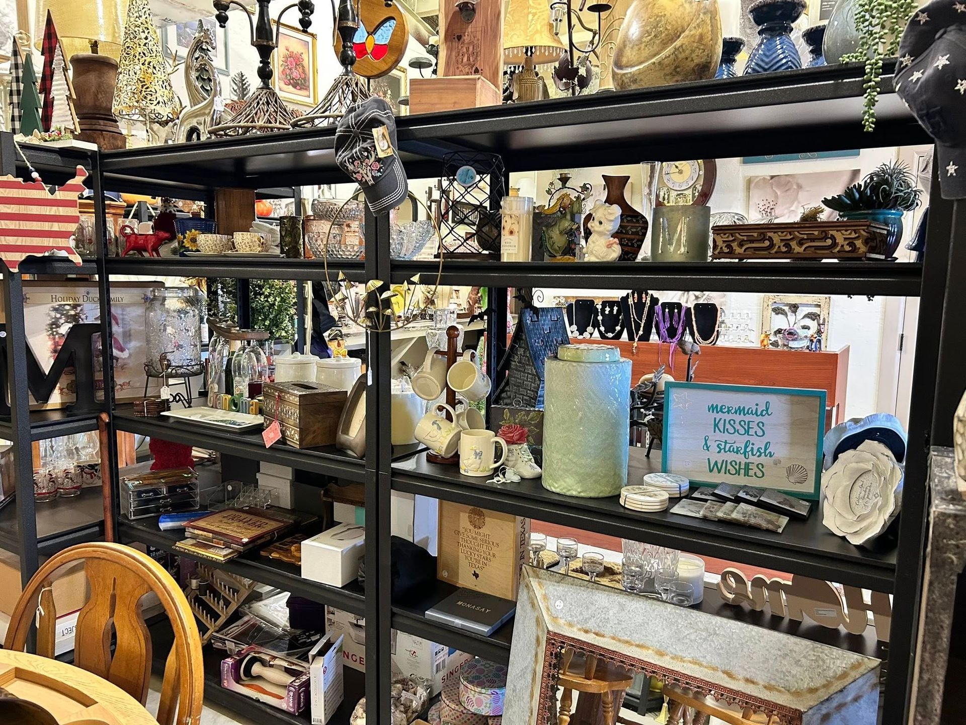 Shelves overflowing with various items for sale at a shop.